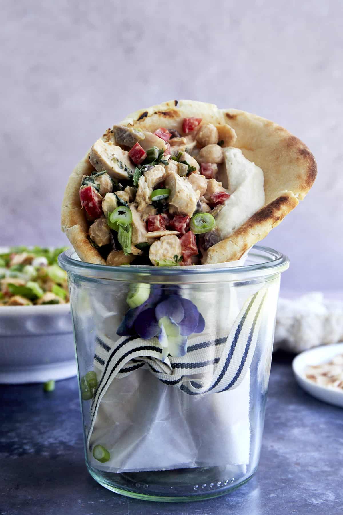 A chickpea chicken salad pita wrap in a jar.