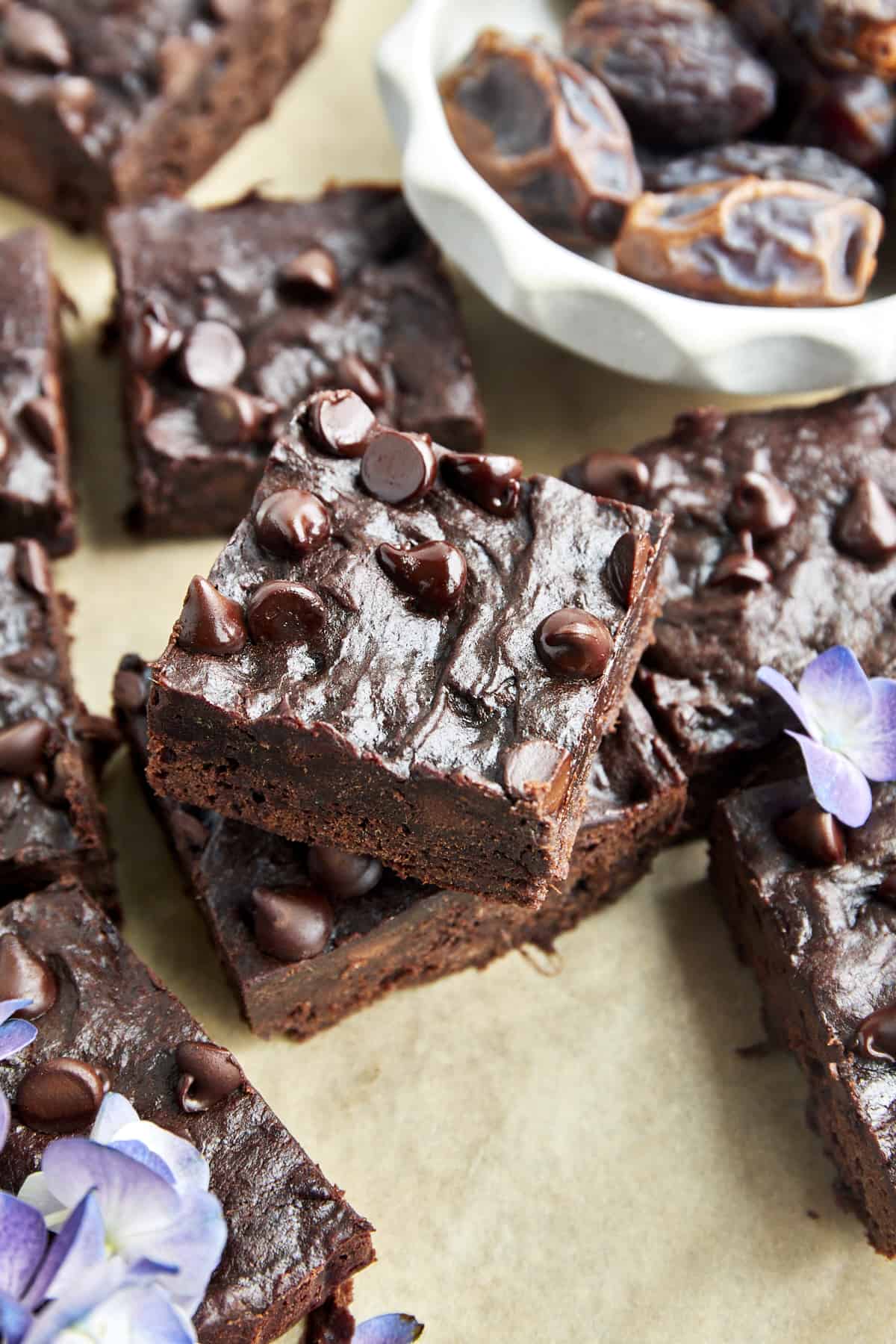 Overhead image of fudgy date brownies topped with chocolate chips.