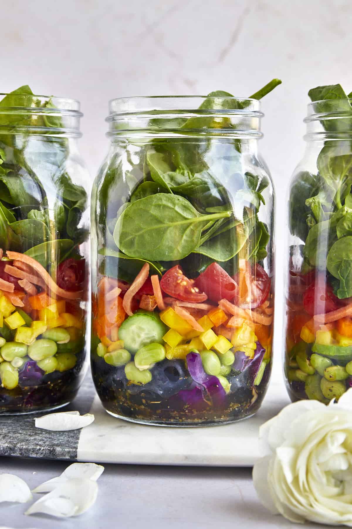 Three mason jars full of rainbow salad.