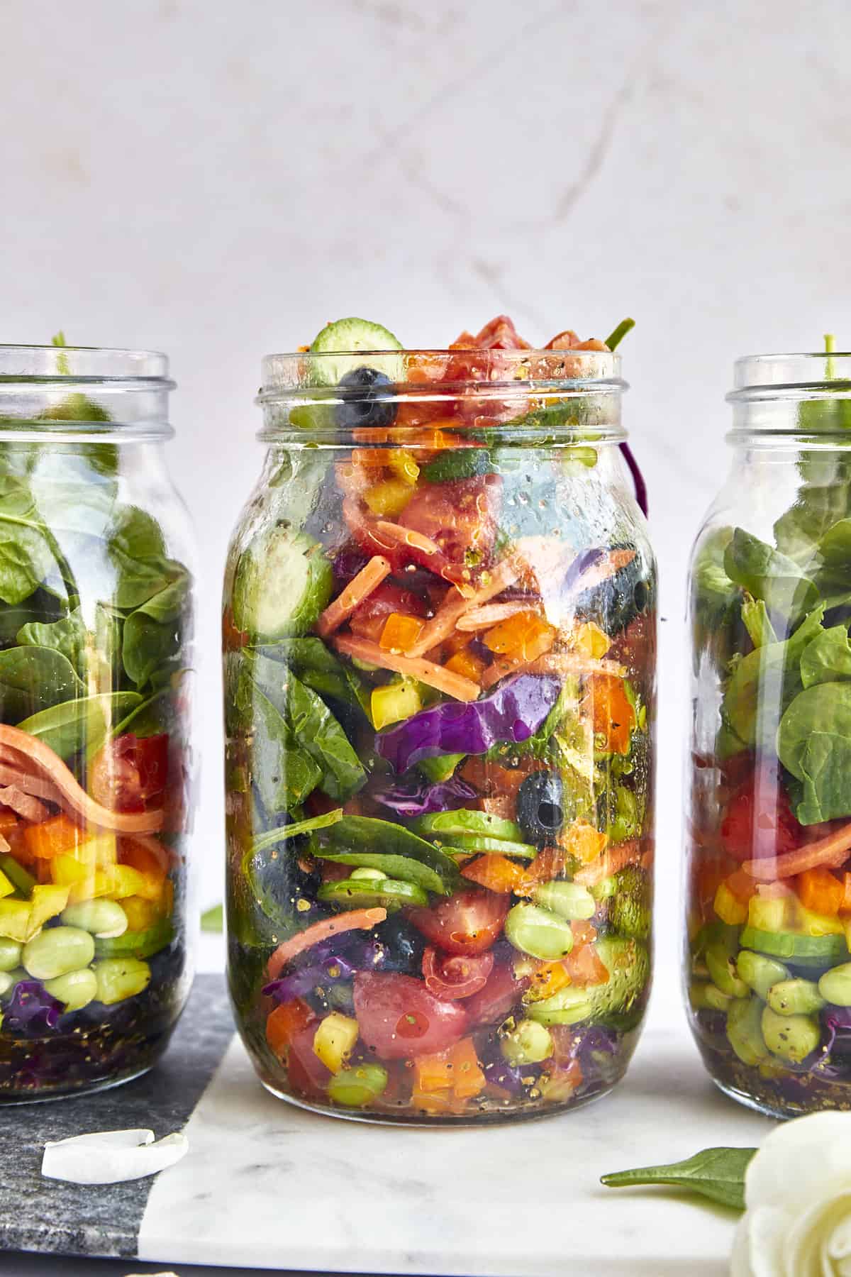 Three mason jars full of rainbow salad.