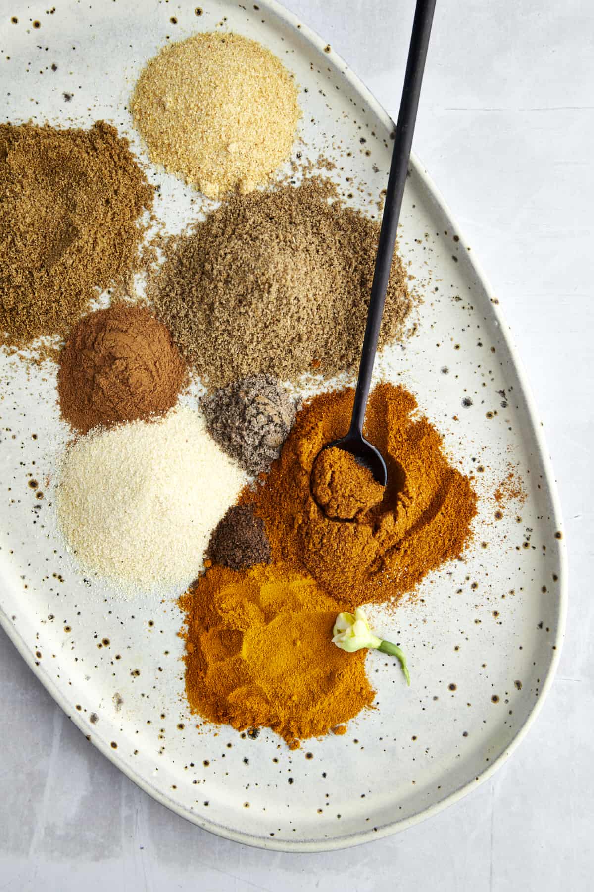 Various spices on a platter to make shawarma seasoning. 