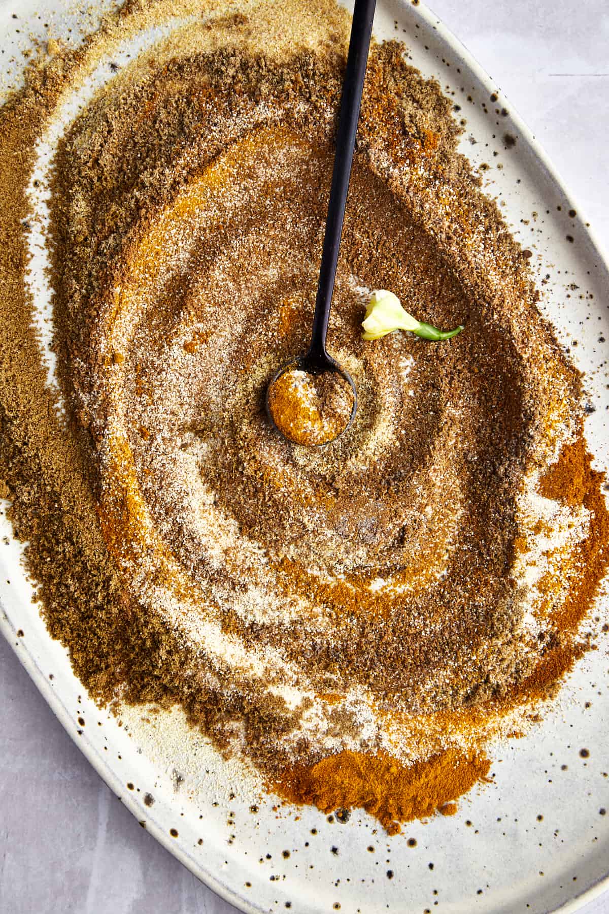 Shawarma spices being mixed together to make a DIY shawarma seasoning blend. 