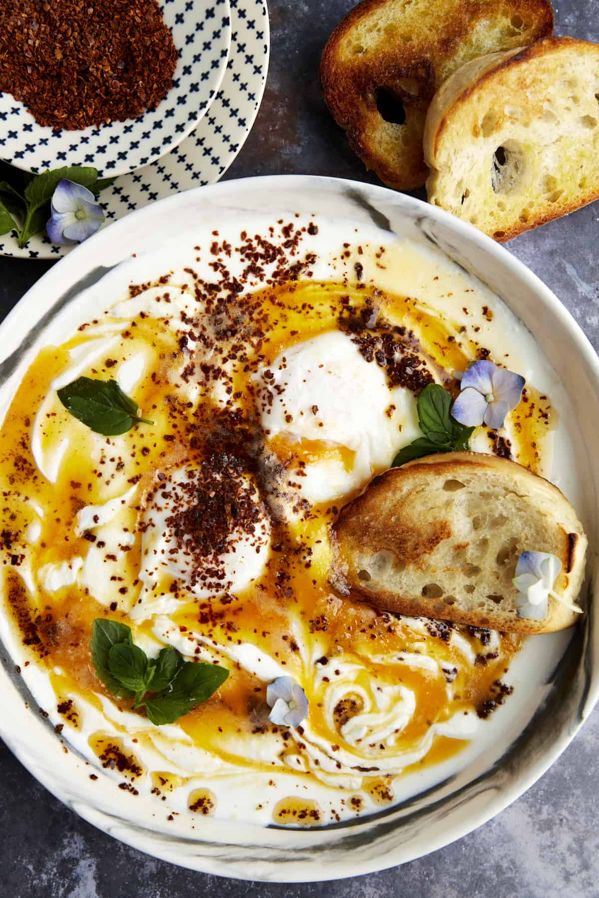 Overhead image of a bowl of Turkish poached eggs with cottage cheese. 