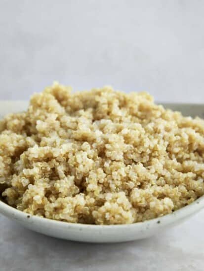 Side view of a bowl of cooked quinoa.