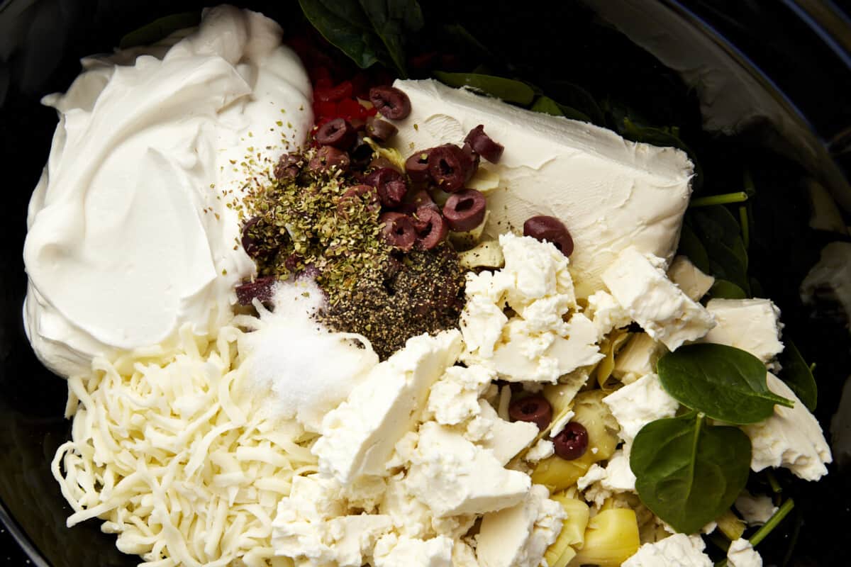 Close up image of ingredients to make Mediterranean-inspired spinach and artichoke dip. 