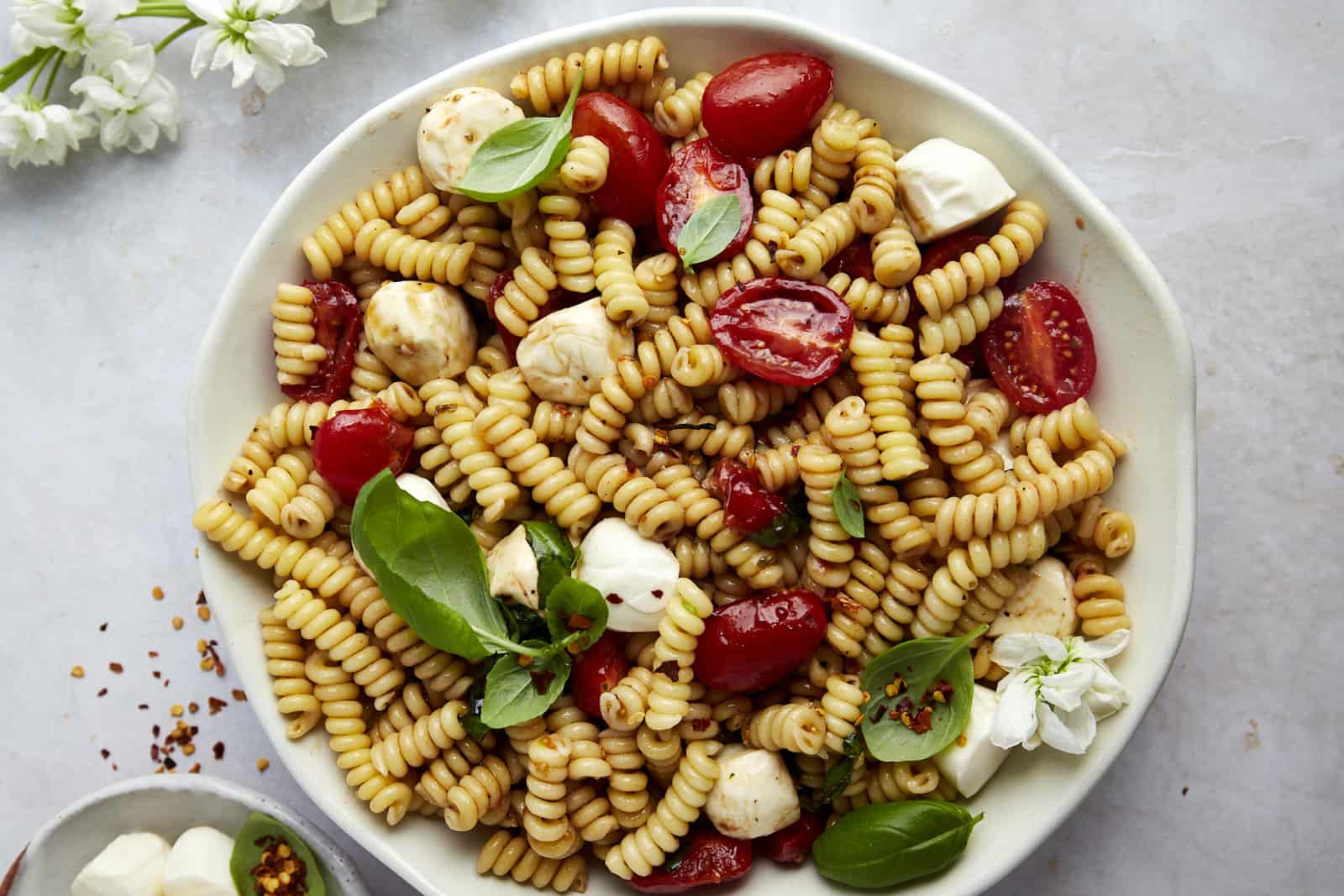A bowl of caprese pasta salad.