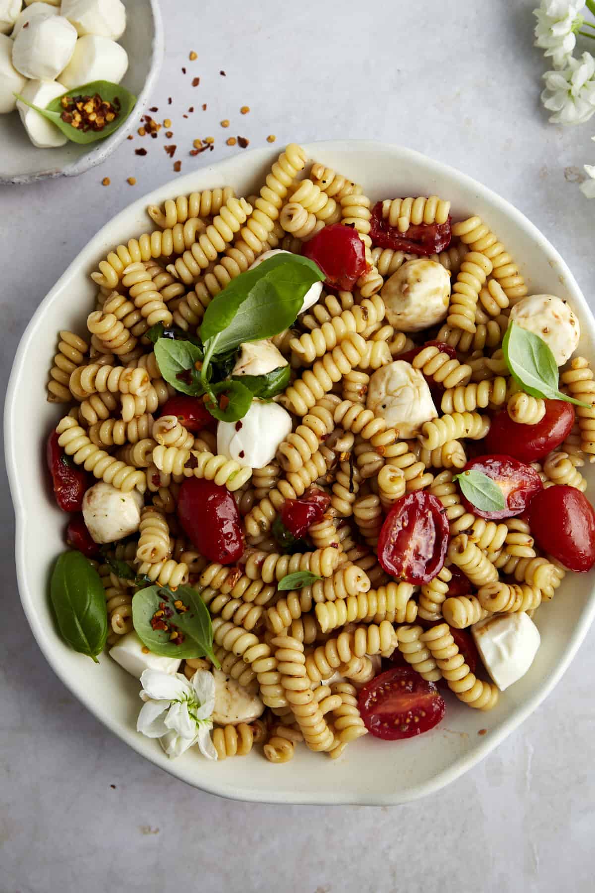 Overhead image of a bowl of caprese pasta salad. 