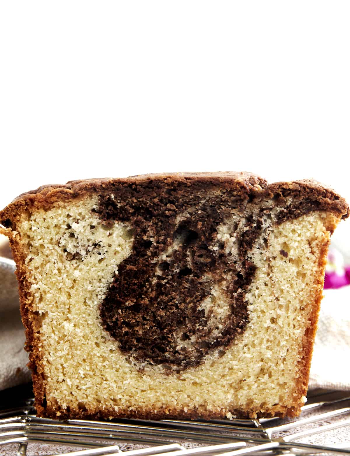 Side view of a sliced loaf of marble cake. 