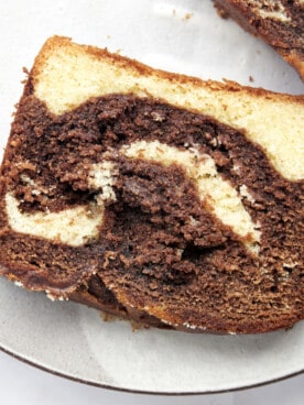 A slice of marble cake on a plate.