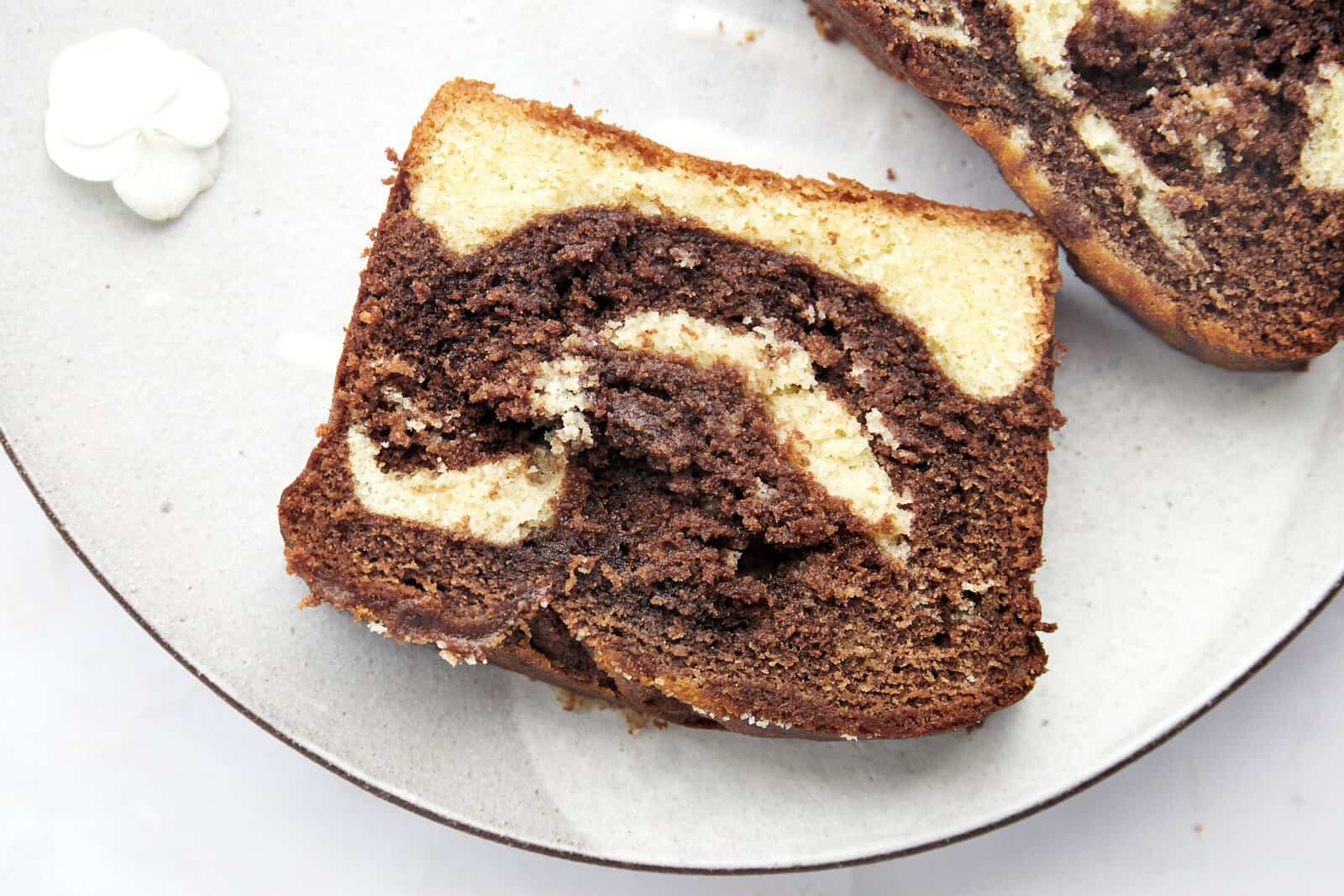 A slice of marble cake on a plate.