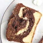A slice of marble cake on a plate.