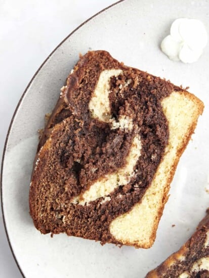 A slice of marble cake on a plate.