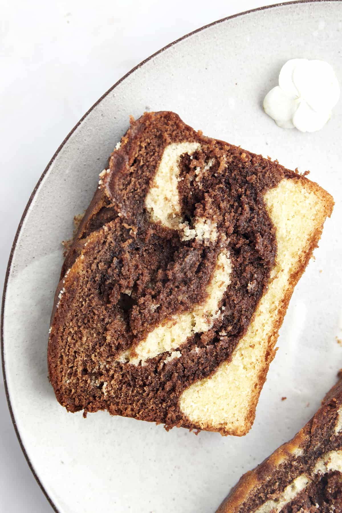 A large slice of marble cake on a plate. 