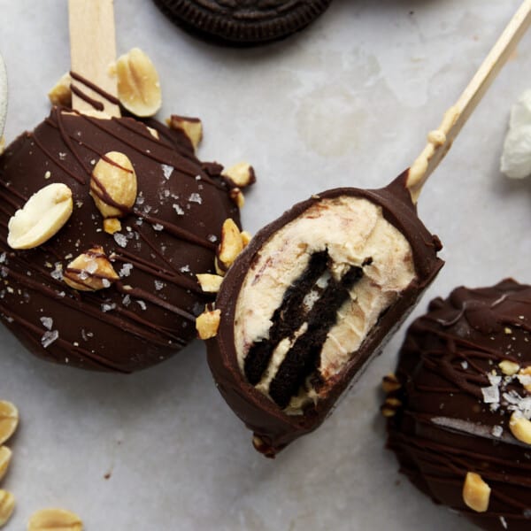 Peanut butter Oreo yogurt popsicles topped with peanuts and salt.