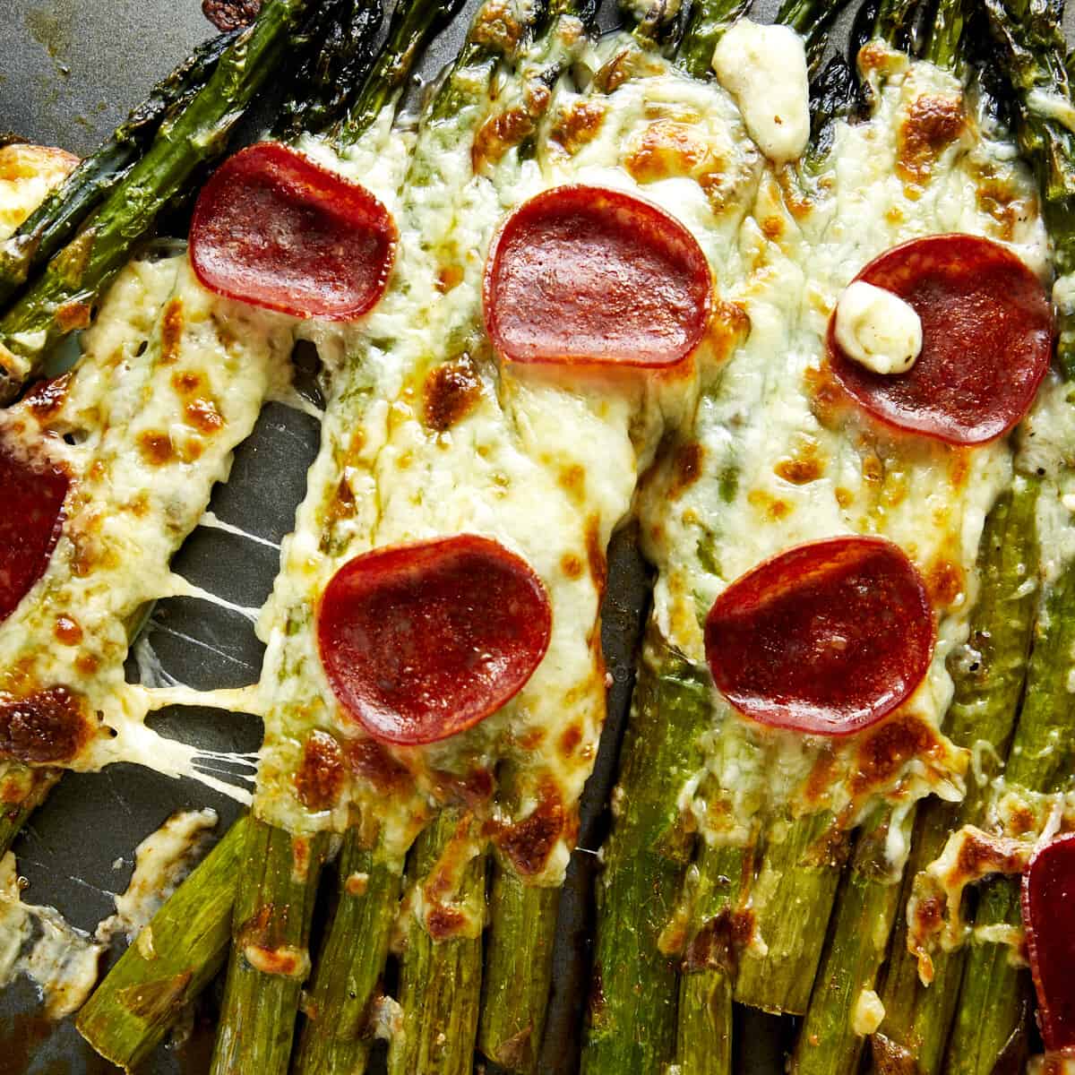 Pizza-flavored oven baked asparagus topped with pepperoni.