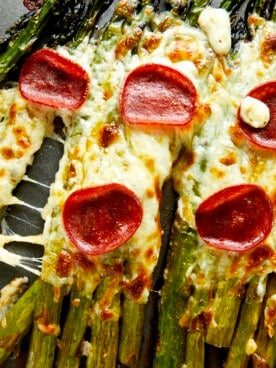 Pizza-flavored oven baked asparagus topped with pepperoni.