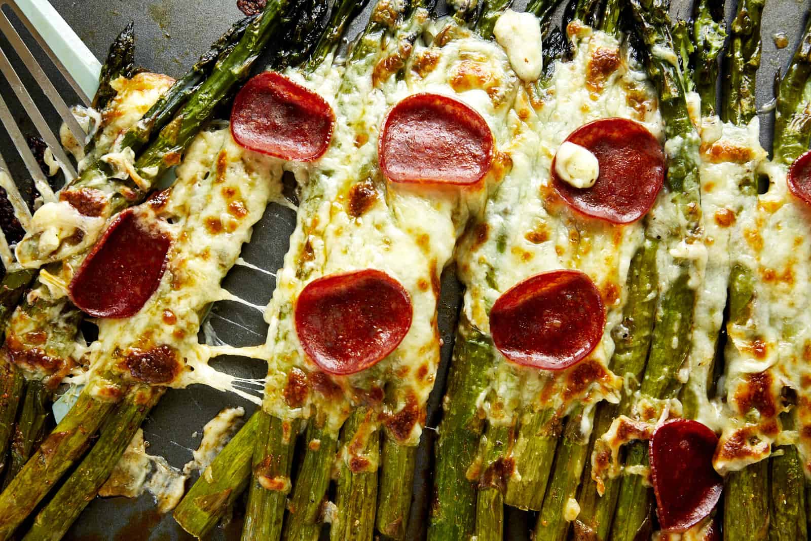 Pizza-flavored oven baked asparagus topped with pepperoni.