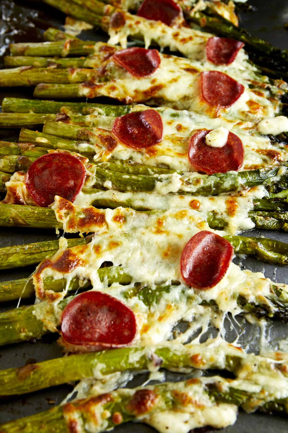 Pizza-flavored oven baked asparagus topped with pepperoni. 