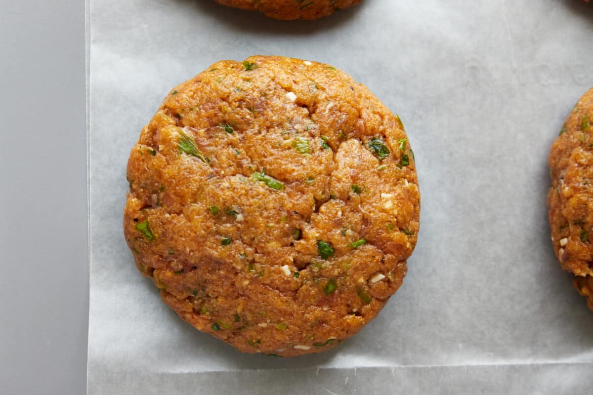 A raw shaped salmon burger. 