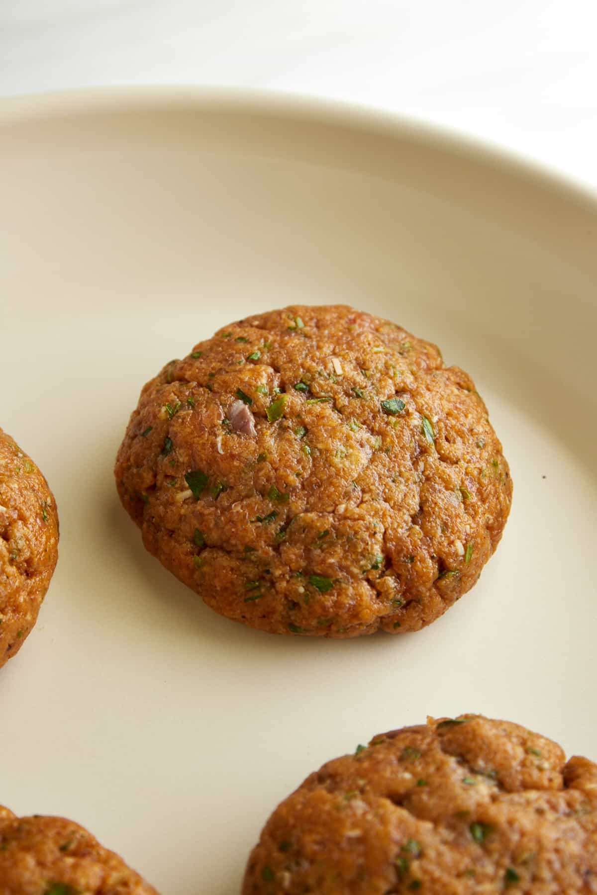 Salmon burgers in a heated skillet. 