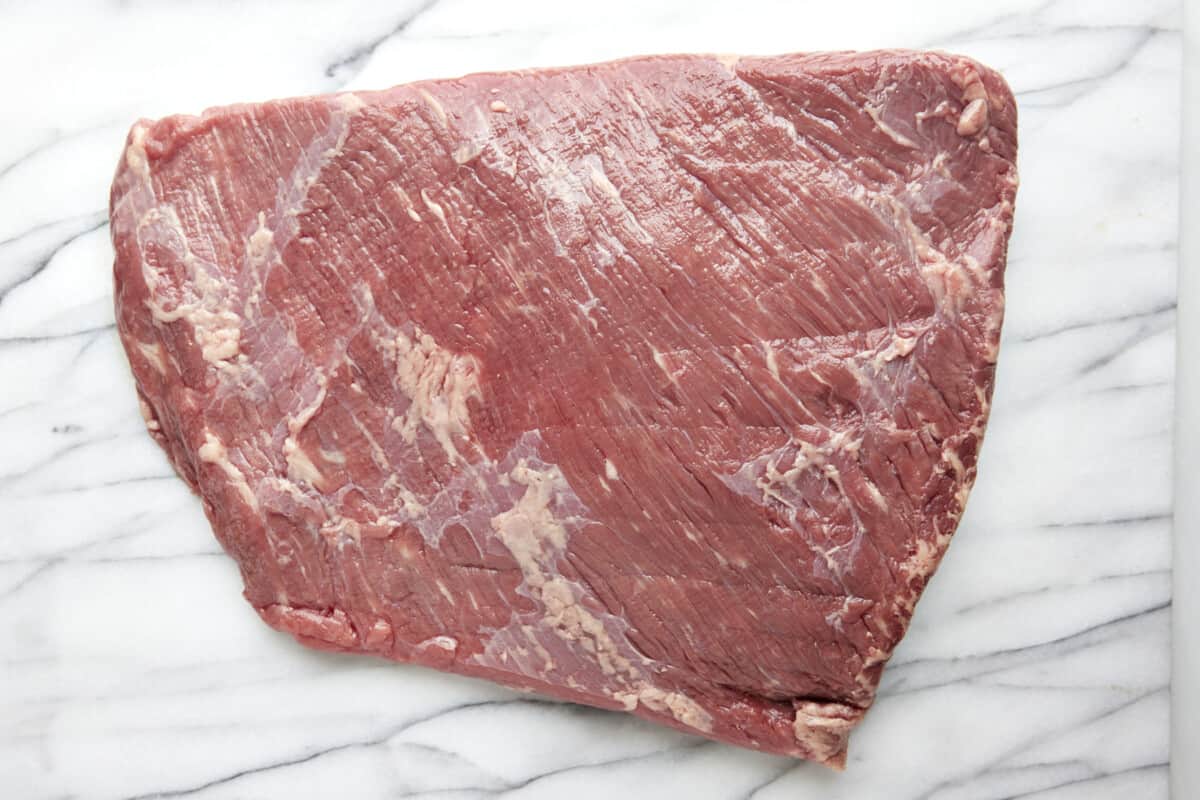 A raw slab of beef brisket. 