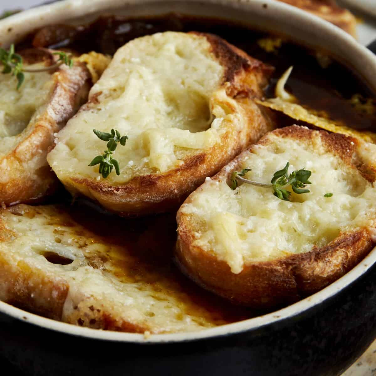 An image of the top of a bowl of easy French onion soup.