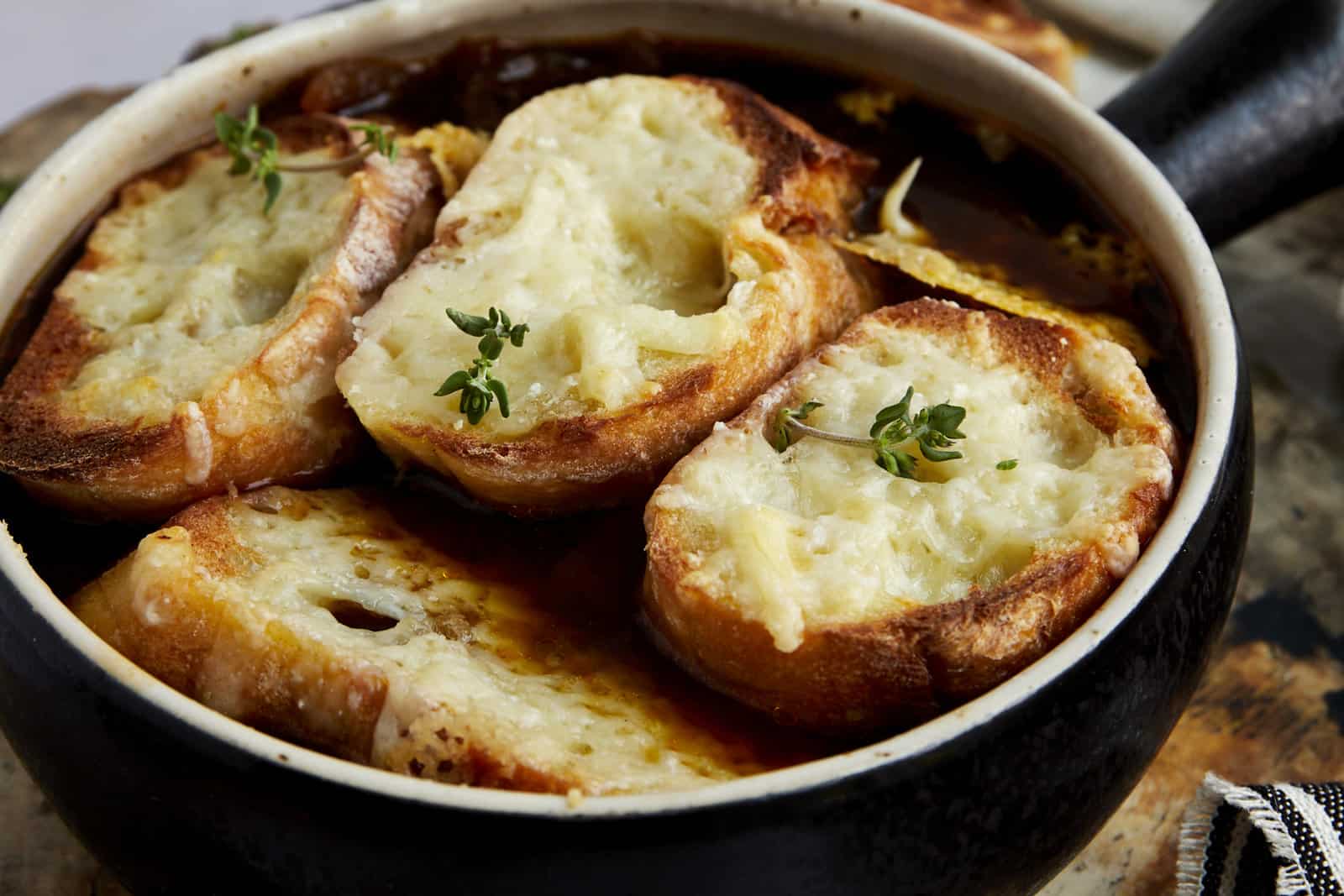 An image of the top of a bowl of easy French onion soup.