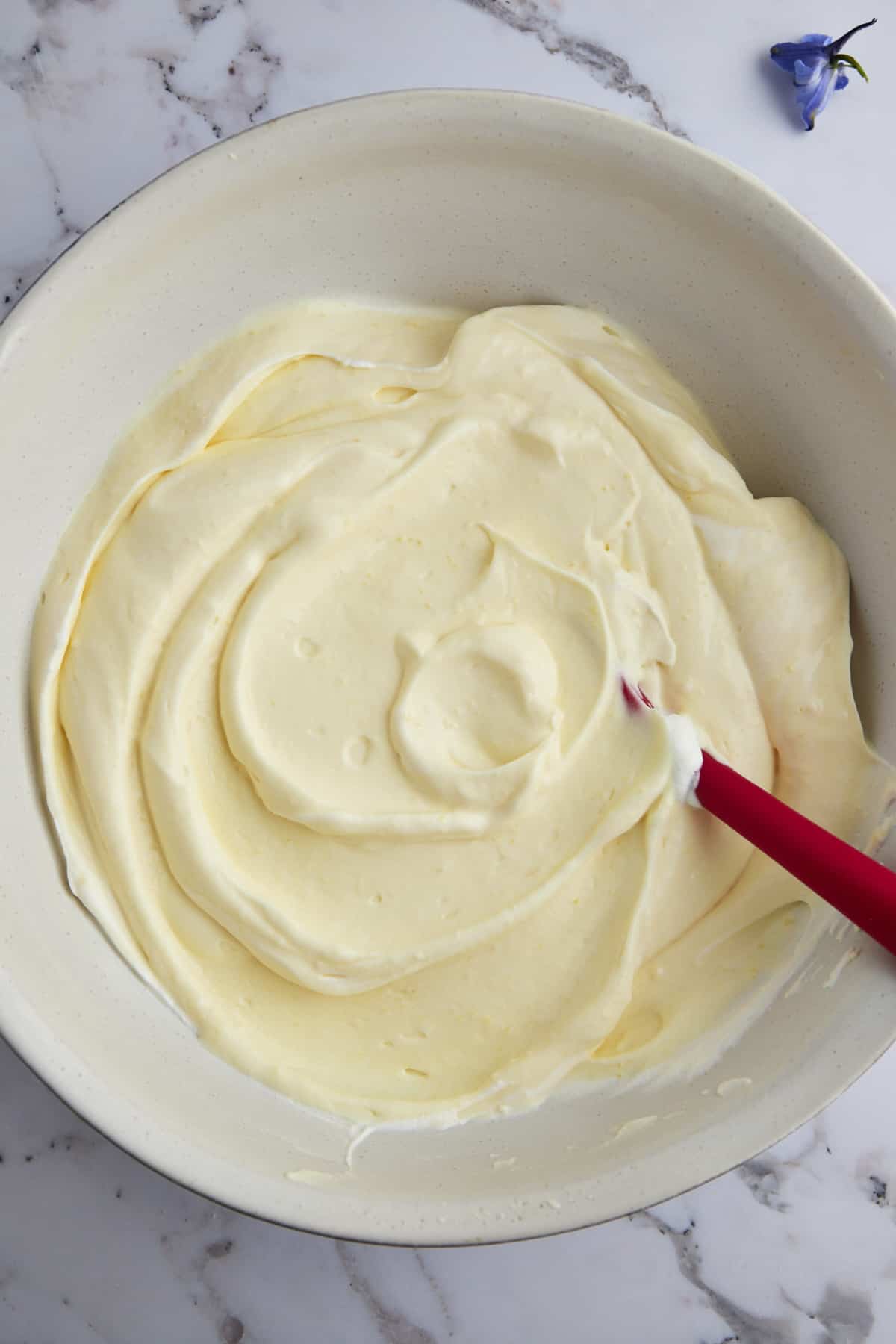 Overhead image of a bowl of pudding flavored whipped topping for a strawberry shortcake recipe. 