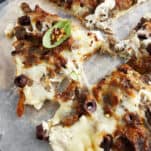 Sliced feta gyro pizza.