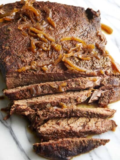 A slow cooker beef brisket partially sliced.