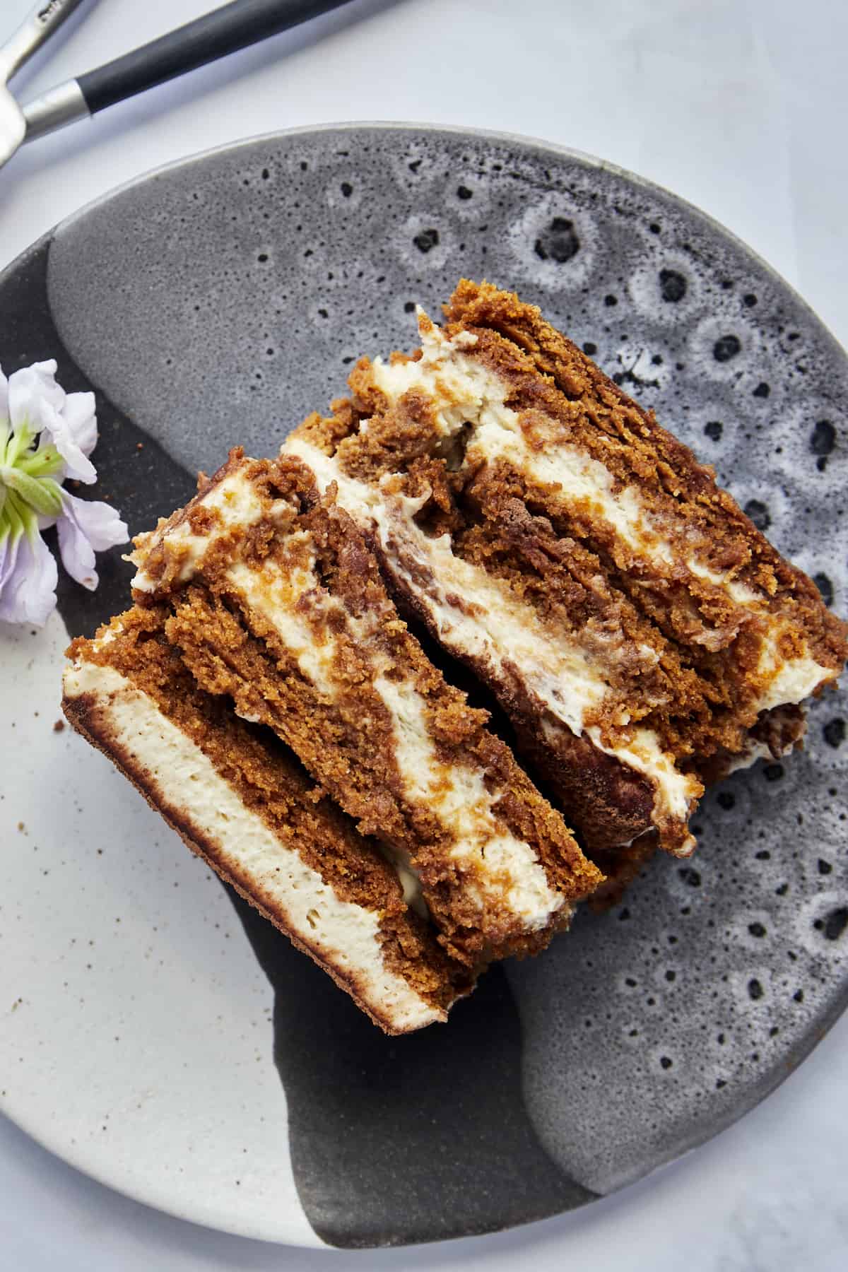 Overhead image of layered Biscoff tiramisu on a plate. 