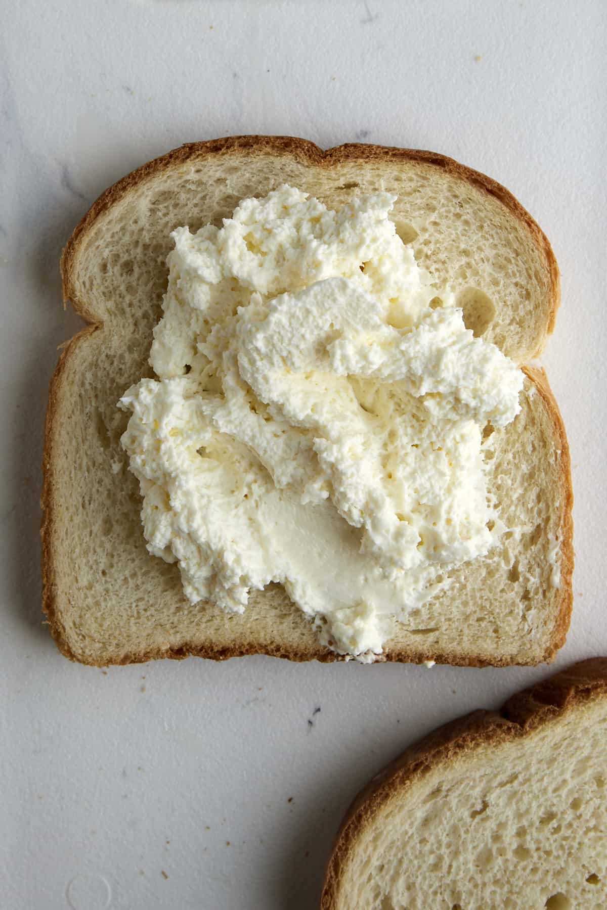 Whipped cream cheese on a piece of bread. 