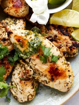 A platter of air fryer lime chicken topped with fresh cilantro.