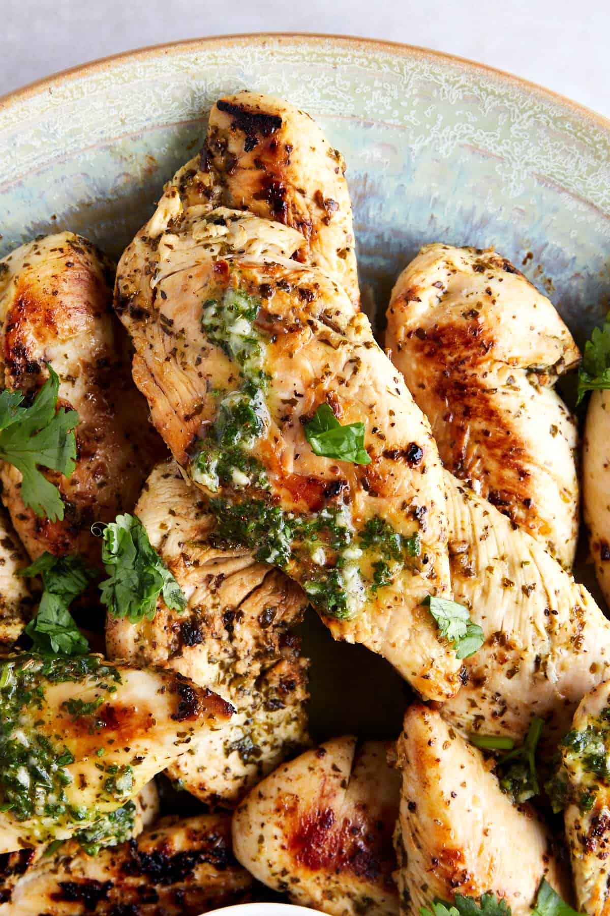 Close up image of cooked lime chicken tenders topped with extra lime marinade. 