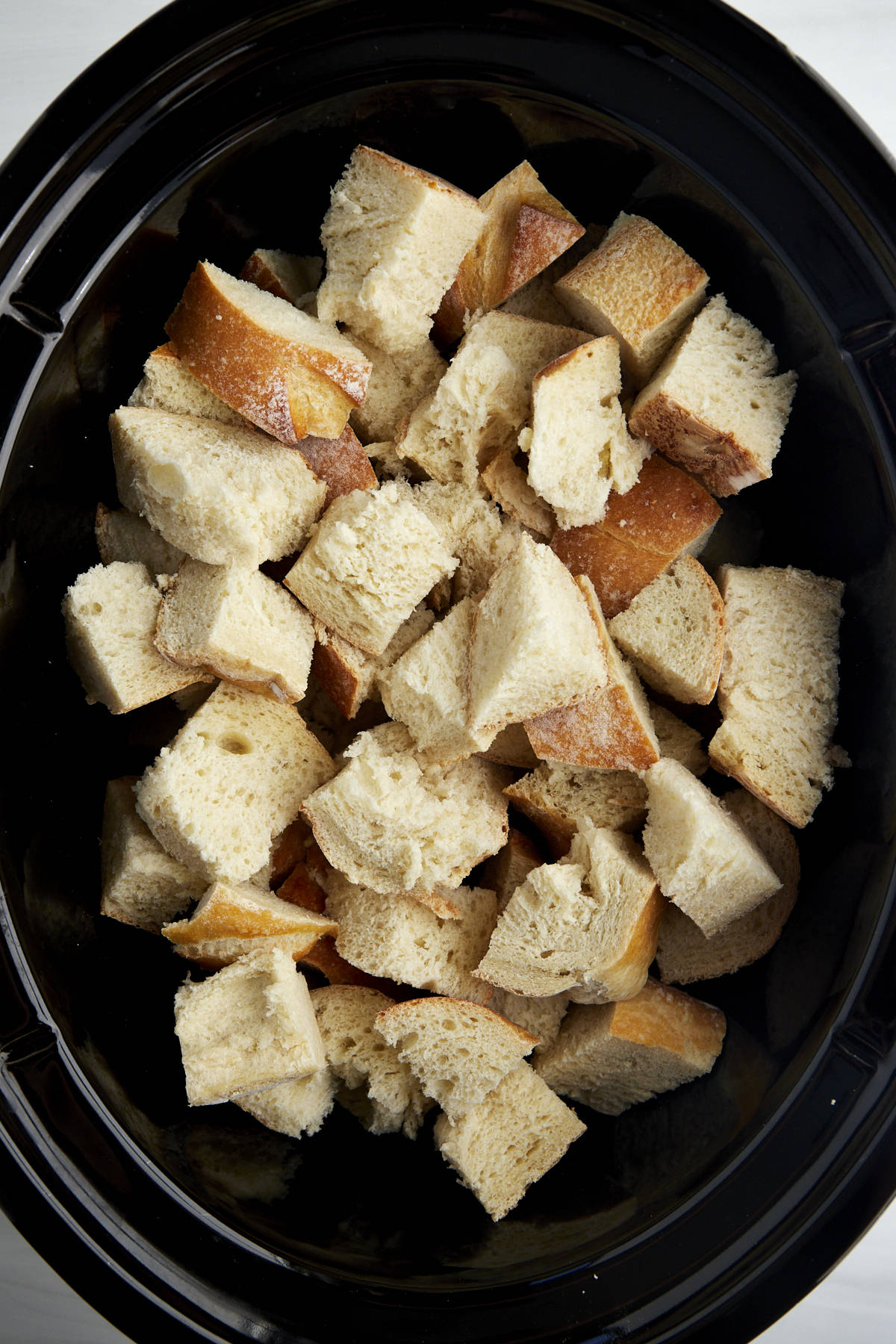 Cubed pieces of bread in a crockpot. 