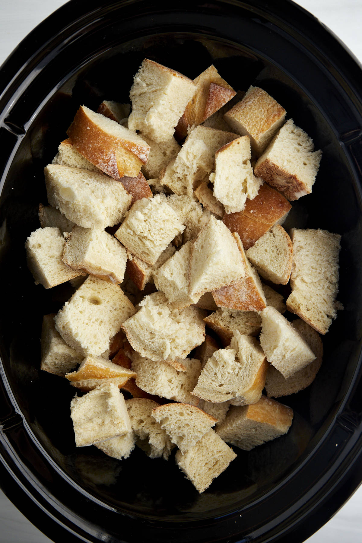 Cubed pieces of bread in a crockpot.