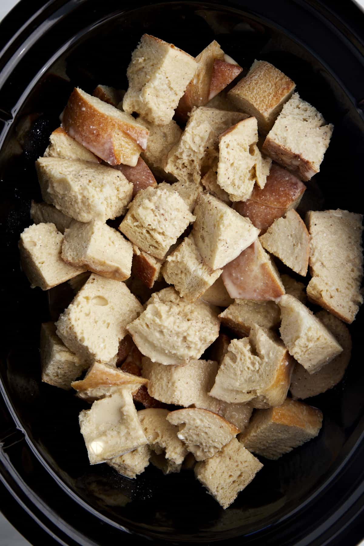 Cubed pieces of bread in a crockpot.