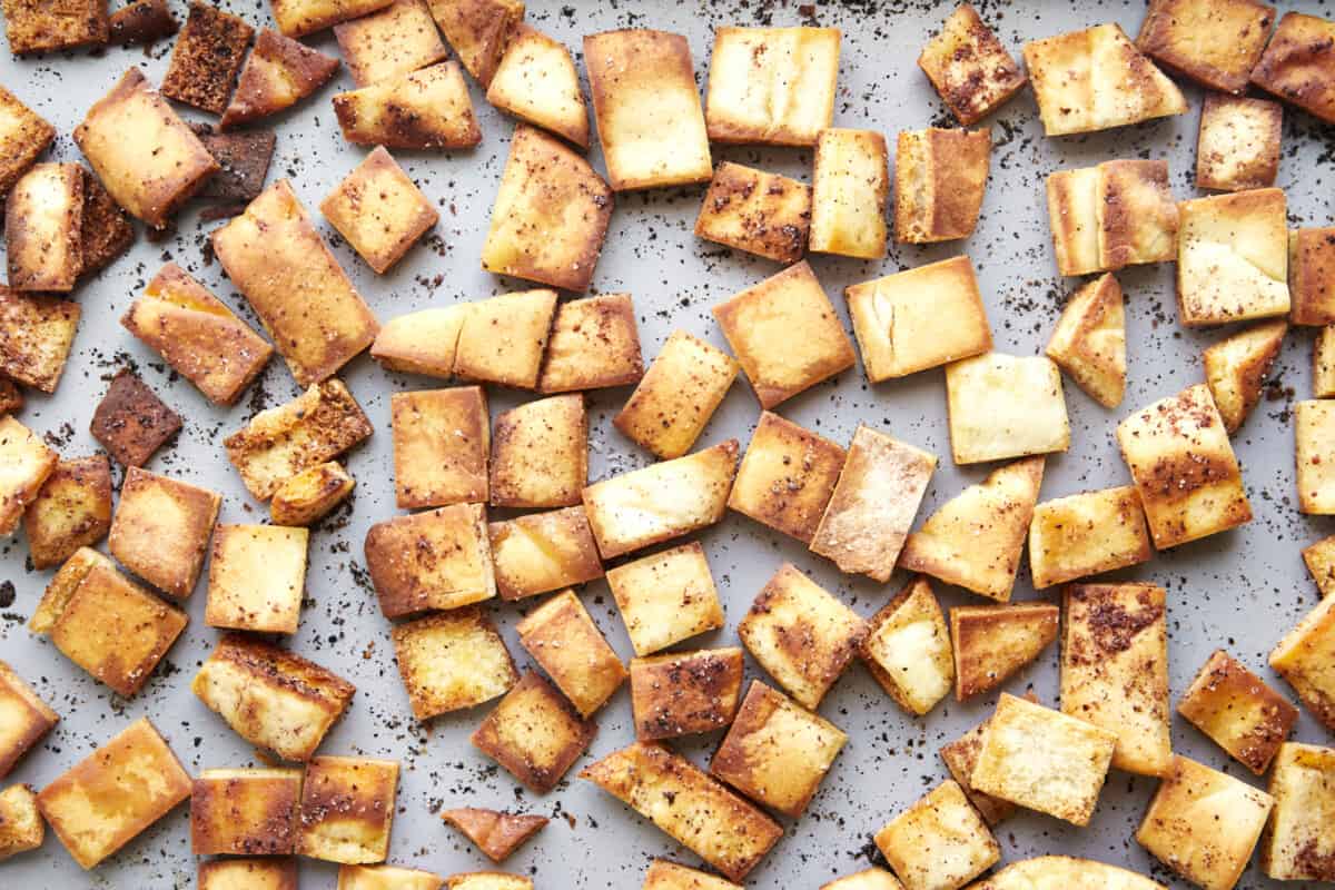 Baked pita chips on a baking sheet. 