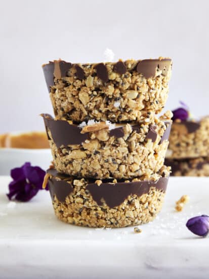 Three no bake peanut butter oat cups stacked on top of each other.