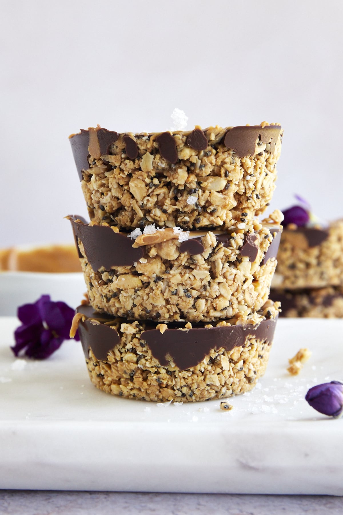 Three no bake peanut butter oat cups on top of each other. 