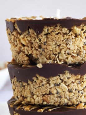 A stack of three no bake peanut butter oat cups on top of each other.