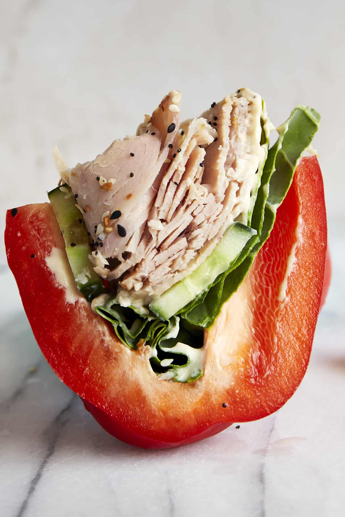 Side view of halve of a low-carb turkey bell pepper sandwich. 