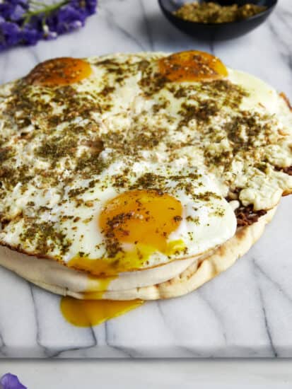 Fried feta eggs topped with za'atar and served over toasted pita with hummus.