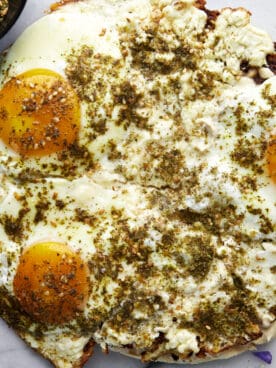 Overhead image of viral fried feta eggs over pita bread.