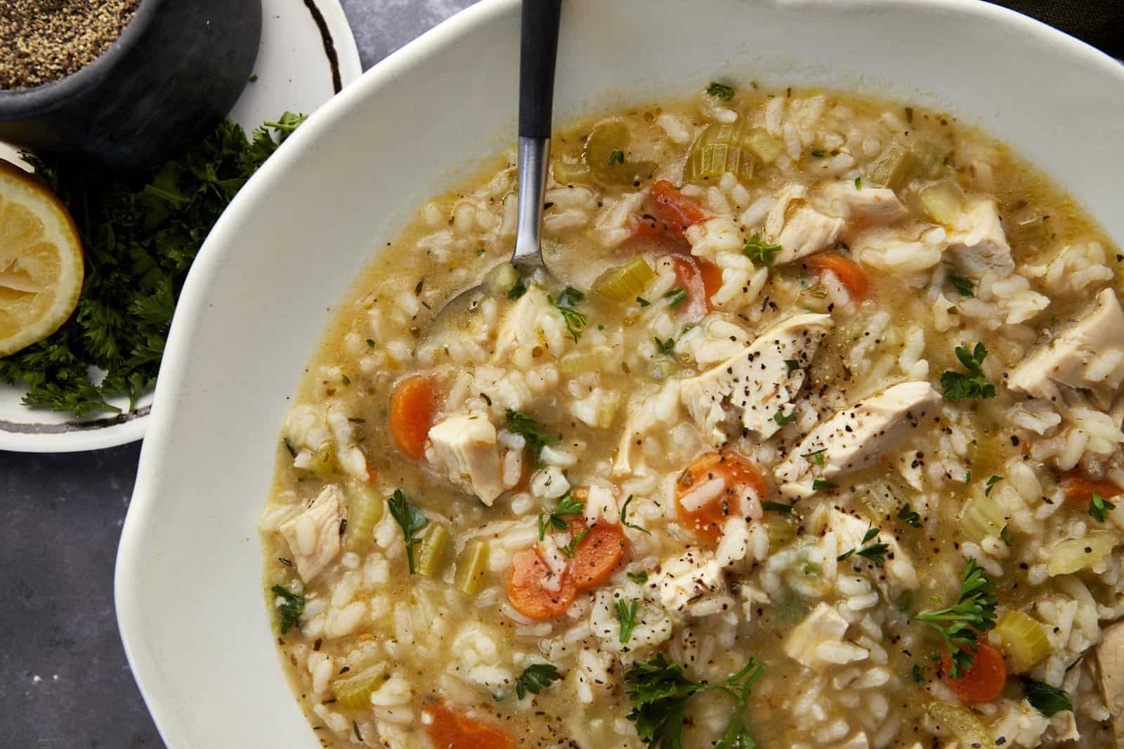 Close up image of a bowl of chicken and rice soup.