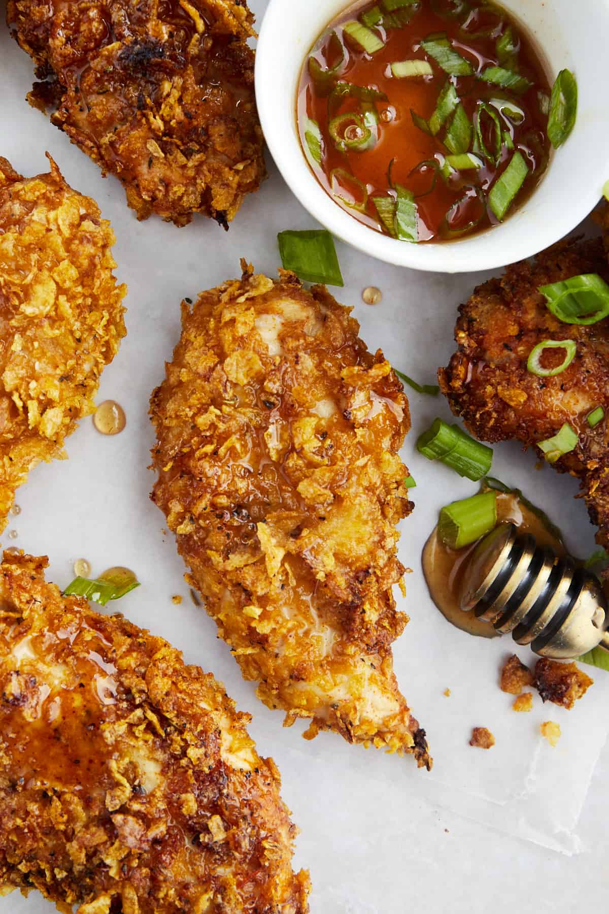 Baked cornflake chicken tenders with a side of hot honey.