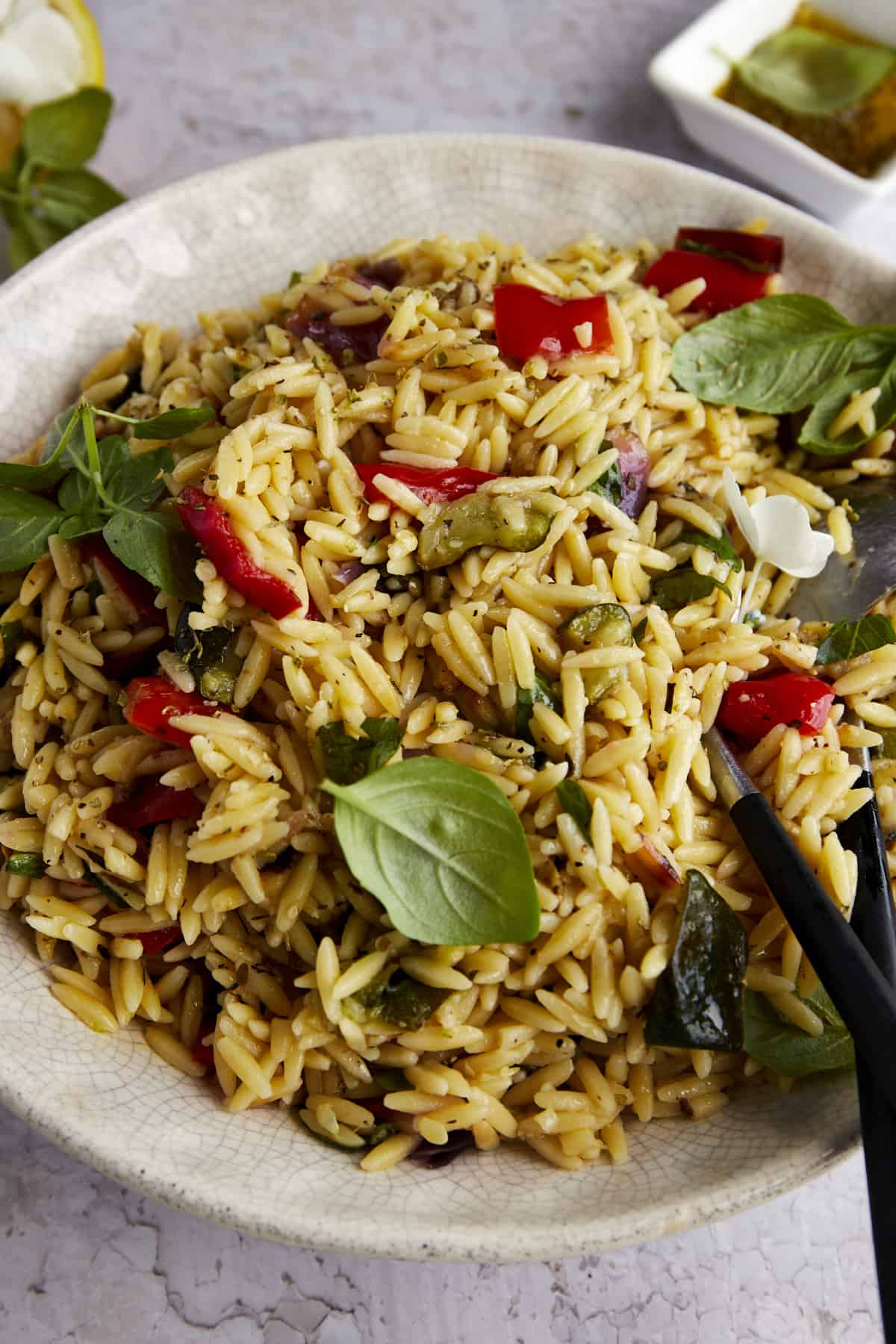 Close up image of a bowl of roasted veggie pasta salad.