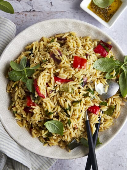 A bowl of roasted veggie pasta salad with orzo.