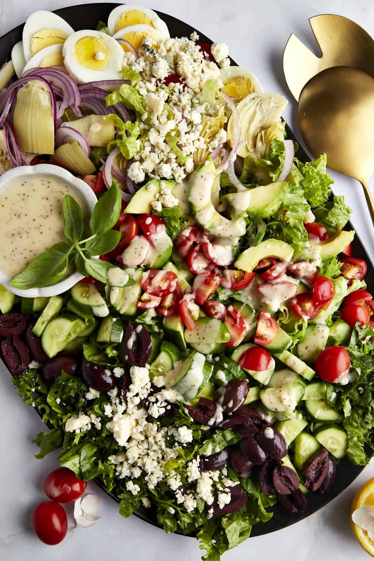 A platte of Middle Eastern Cobb Salad with dressing on the side.