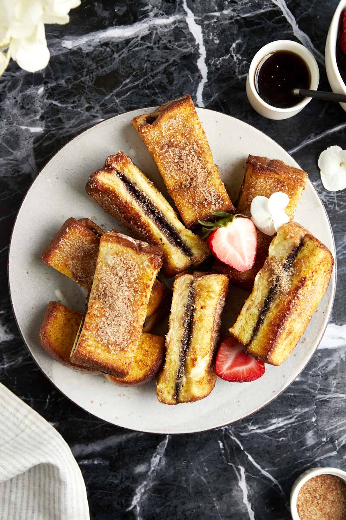 Overhead image of cinnamon sugar Nutella French toast sticks on a plate. 